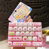 A pink acrylic keyboard keycap keychain featuring various cartoon animal designs like a bunny and other cute characters.