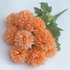 A bouquet of artificial orange hydrangeas and green camellia leaves.