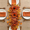 Autumn sunflower teardrop swag with maple leaves in orange and gold tones displayed on a neutral linen background.