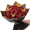 A bouquet of ten deep red glitter artificial roses with a gold crown decoration.