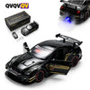 A black remote control car model with racing features and flashing blue lights is shown next to its packaging.