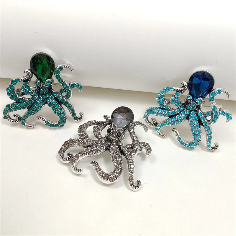 A set of three vintage marine life brooch pins featuring iridescent green, blue, and silver-toned glittery designs.