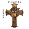 A wooden cross wall decor featuring a sculpted face with a crown of thorns.