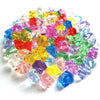 A pile of colorful crystal ice cube acrylic stones in various shades of red, green, blue, and purple.