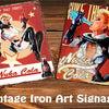 A collection of vintage iron art signage featuring Germlins and Nuka Cola designs on wooden planks.
