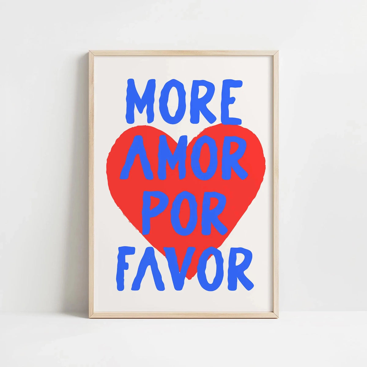 Framed canvas wall art featuring the text MORE AMOR FOR FAVOR in blue and red lettering on a white background.