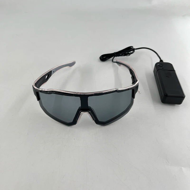 A pair of black light up wire party glasses with a black cord and battery pack.