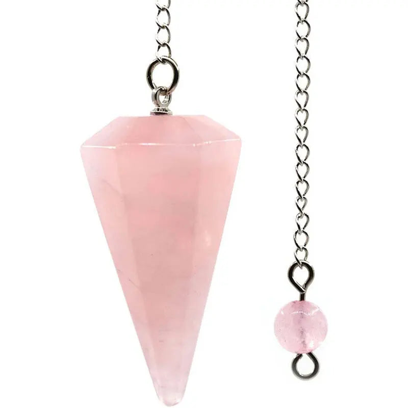 A clear pink gemstone point suspended on a silver chain, used as a natural stone pendulum.
