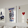 Three framed art prints featuring lucky themes including a bird, text, and hearts.