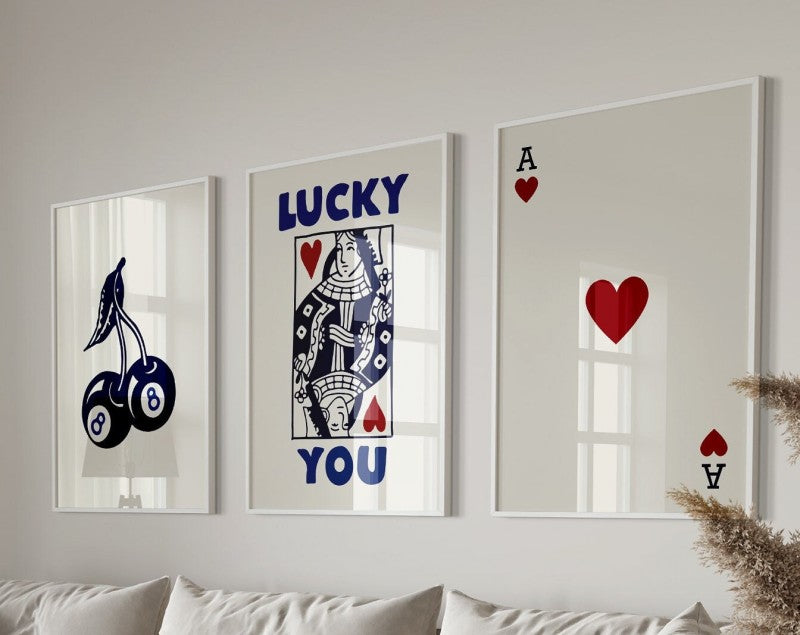 Three framed art prints featuring lucky themes including a bird, text, and hearts.