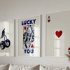 Three framed art prints featuring the words LUCKY and YOU with heart and A symbols