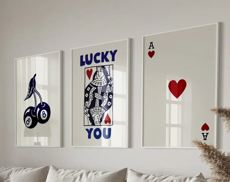 Three framed art prints featuring the words LUCKY and YOU with heart and A symbols