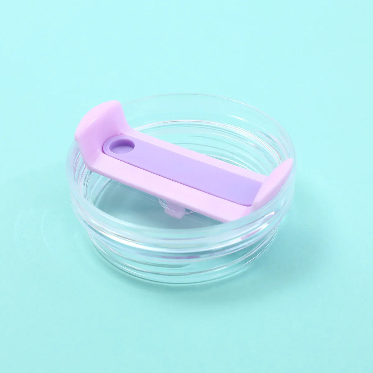 A purple replacement tumbler lid with a sliding mechanism is shown inside a clear glass jar.