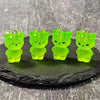 Three glow-in-the-dark green cartoon kitty duck resin charms displayed on a dark surface.