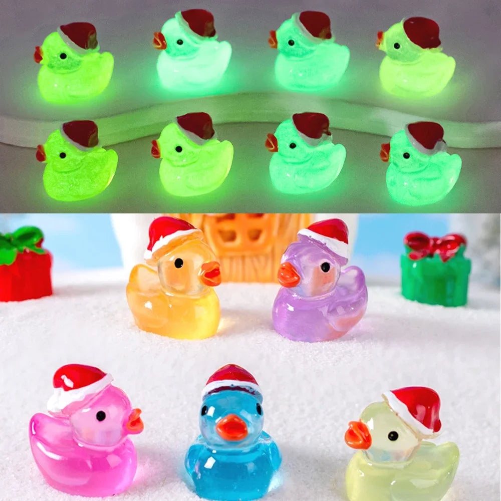 A collection of glow-in-the-dark Christmas duck figurines with Santa hats in various colors.