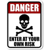 A vintage red and white sign with the word DANGER and text that reads ENTER AT YOUR OWN RISK.