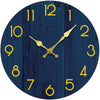 A dark blue wooden wall clock face with gold-colored hands and numbers.