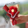 A hand holds a bouquet of red crochet flowers wrapped in brown paper, with dimensions marked.