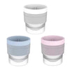 A set of stackable spherical ice molds in light gray and pink for whiskey and cocktails.