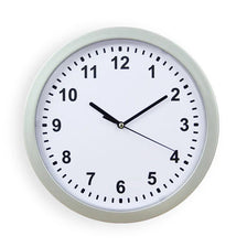 A round, light gray wall clock with a white face and black hands displaying the time.