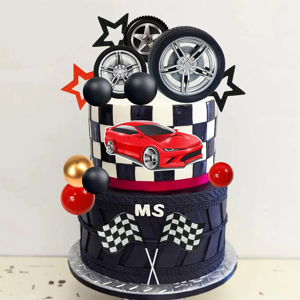 A multi-tiered cake decorated with a red sports car, black and white checkered patterns, and racing wheels.