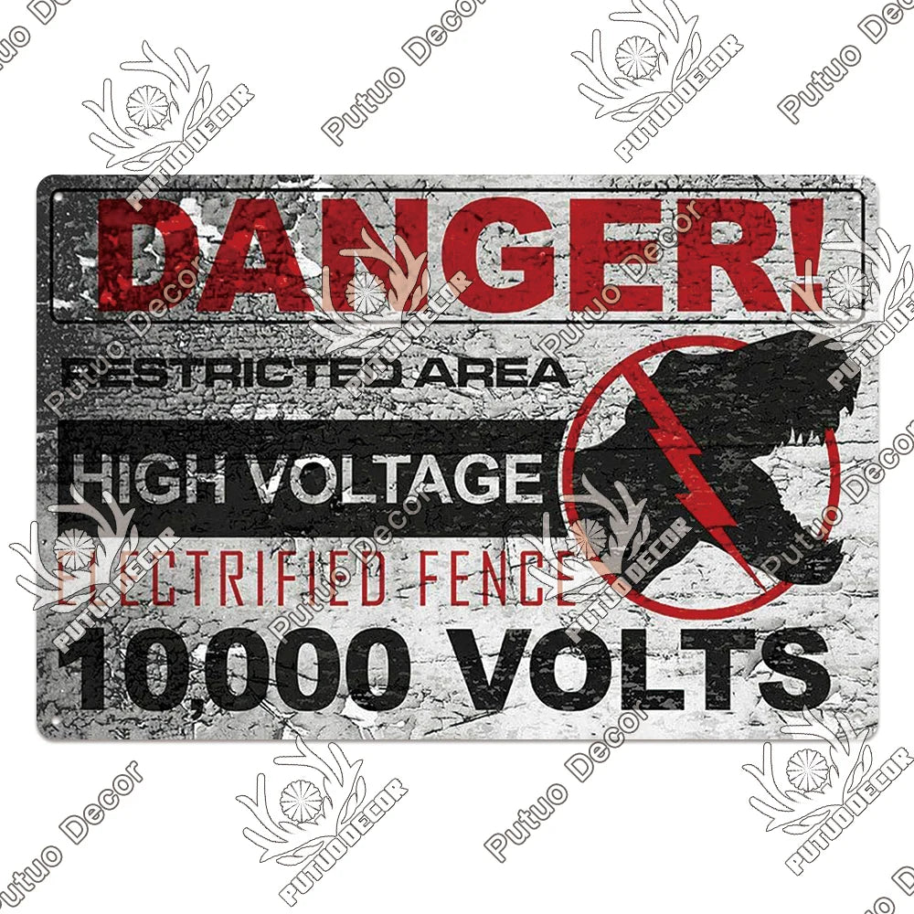 A vintage metal warning sign with red text and black background displaying DANGER, restricted area, high voltage, and 10,000 