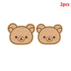 A pair of light brown felt cartoon bear face wall decor panels for children's rooms.