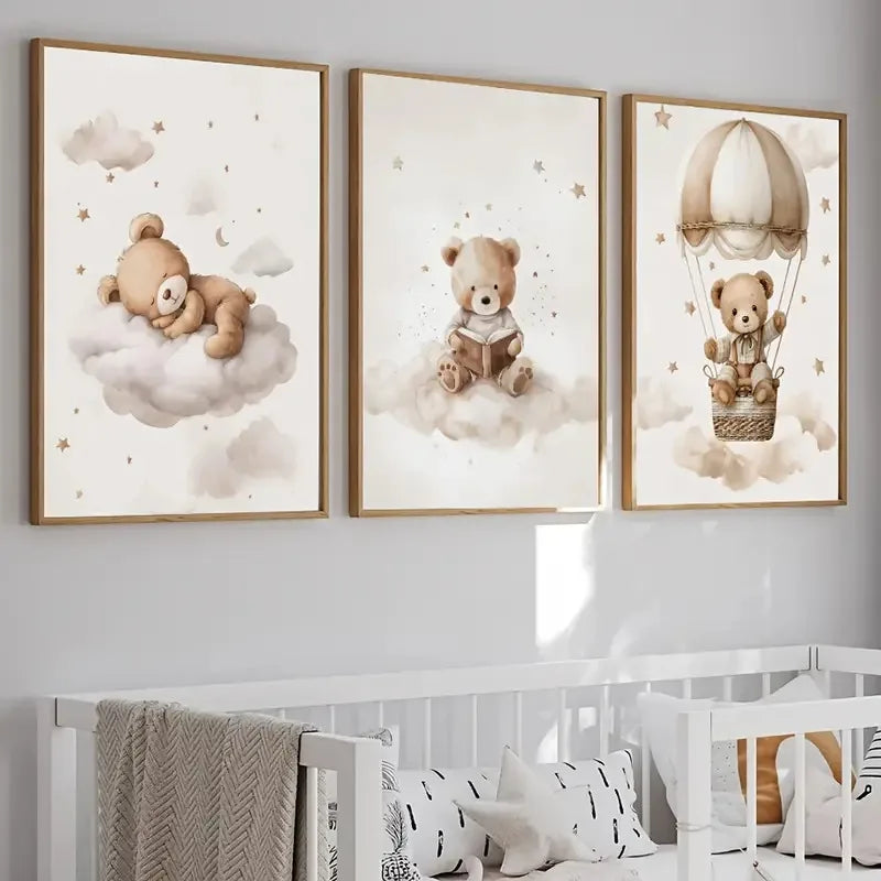 A set of three framed canvas prints featuring teddy bears on clouds and a basket with a baby in a wicker basket.