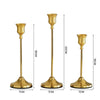 Set of three elegant gold metal candlesticks with flared bases and slender stems.