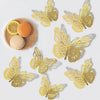 A set of nine gold butterfly wall decor cutouts displayed on a white background with citrus fruit.
