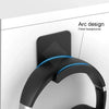 A black arc design headphone stand fitted for use on a desk or wall.