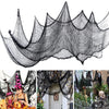 Black creepy gauze cloth netting draped to resemble a spooky, jagged silhouette for Halloween decor