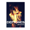 A dark, moody photograph of a person with long hair and tattoos, likely featuring the Deftones band.