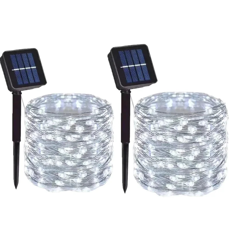 A set of solar powered fairy lights with solar panels for outdoor garden décor