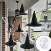 Classic black witch hats with hanging rope used as Halloween décor displayed outdoors.