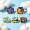 A set of five enamel pins featuring Van Gogh's Starry Night and other classic art motifs on a light blue background.