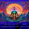 A vibrant tapestry featuring a meditating figure with glowing chakras set against an orange and purple cosmic background.