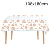 A long white table covered with a colorful rainbow pattern, featuring arched rainbows in pastel colors.