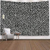A black and white leopard print wall tapestry featuring a modern chair in the foreground.