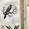 Black raven silhouette on a bare tree branch metal wall art displayed next to a white door frame.