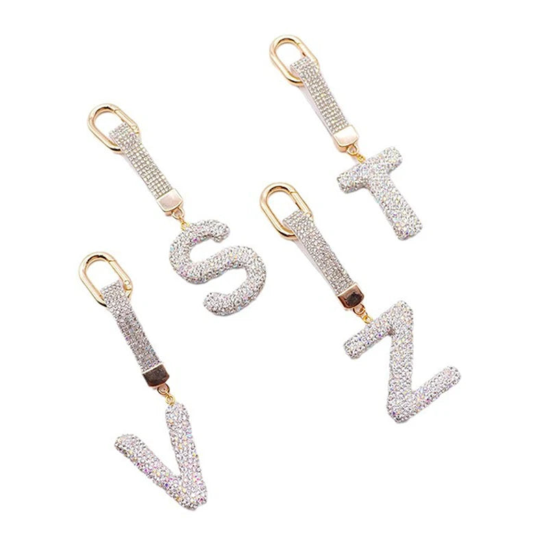 A set of crystal letter keychain charms including S, T, and Z.