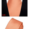 A close-up view of a peach or coral colored silk necktie folded and displayed against a black background.