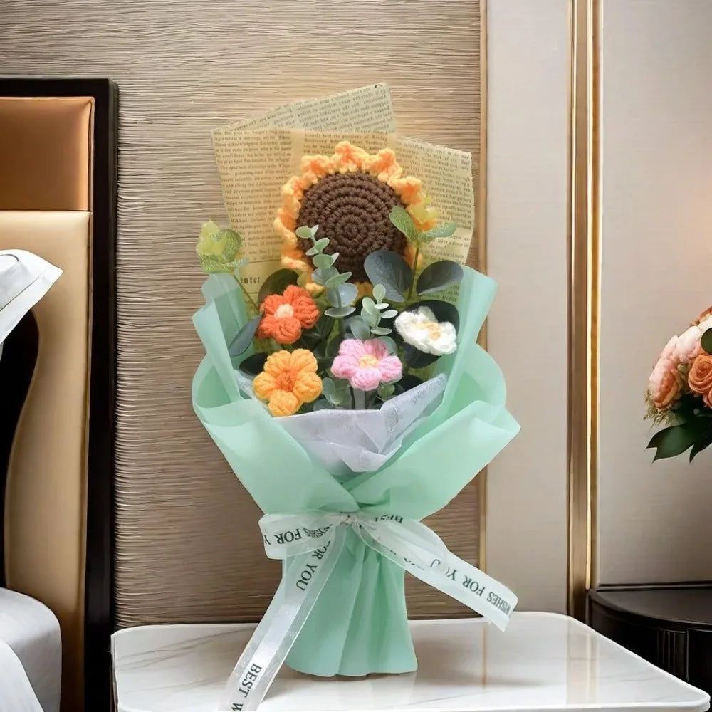 A bouquet of handmade sunflower daisy crochet flowers wrapped in light green paper and tied with a white ribbon.