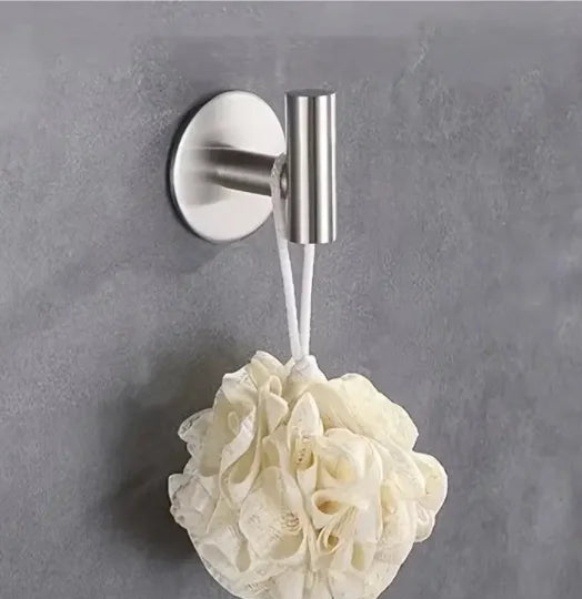 A silver magnetic wall-mounted kitchen storage rack with a narrow edge is shown against a gray wall.