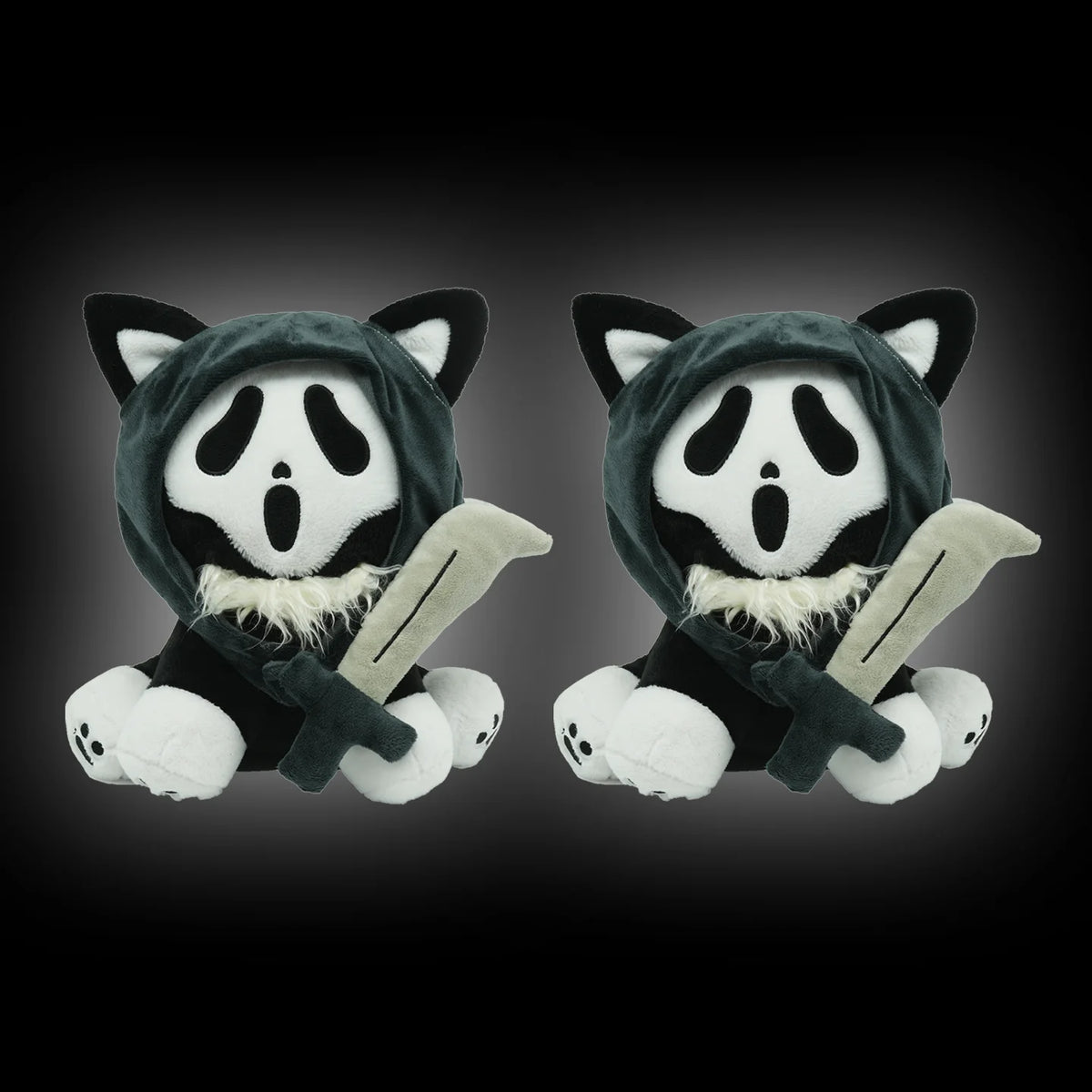 A plush toy resembling a cat face with black and white markings, wearing a hood and holding a knife.