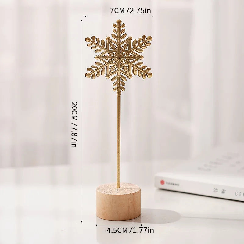 A golden iron snowflake ornament on a wooden stick with measurements shown.