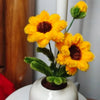 A bouquet of bright yellow and orange flowers made from chenille stems for DIY crafts