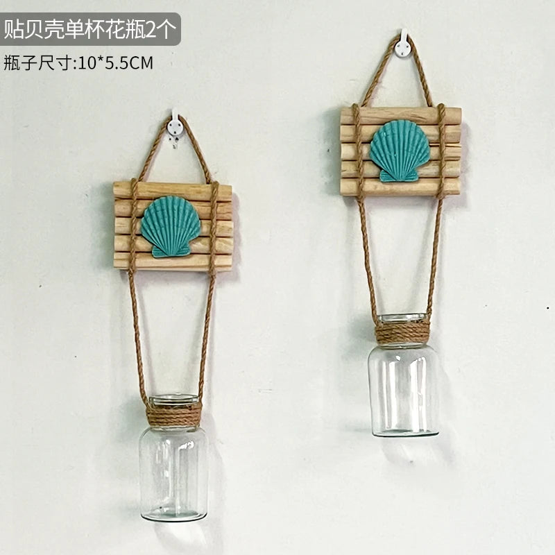 Two wooden and straw macrame plant hangers with blue seashell decorations for indoor plants