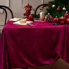 Burgundy red velvet rectangular tablecloth set for elegant dining with festive holiday decorations