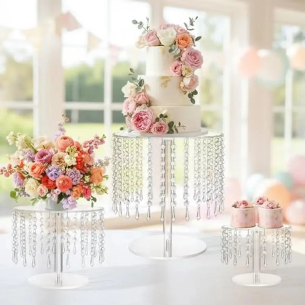 Elegant transparent acrylic cake display rack with pink and peach floral arrangements.